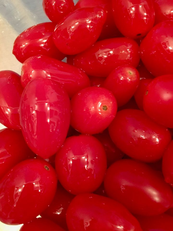 Early-season grape tomatoes, lightly slicked with olive oil