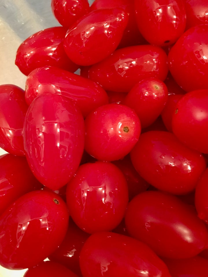 <p>Early-season grape tomatoes, lightly slicked with olive oil</p>