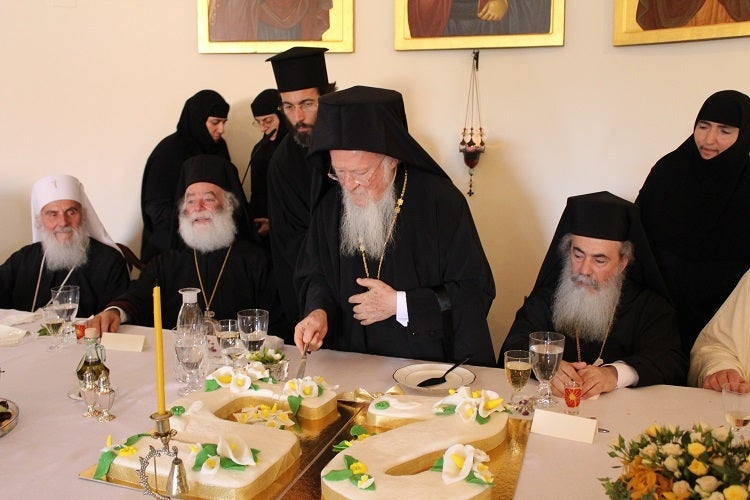 <em>His All-Holiness cuts the surprise congratulatory cake representing his twenty-five years on the Ecumenical Throne, at th