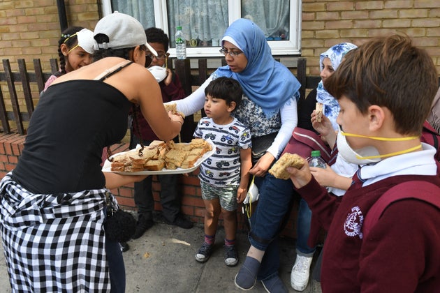 Sandwiches are handed out to local residents close to the