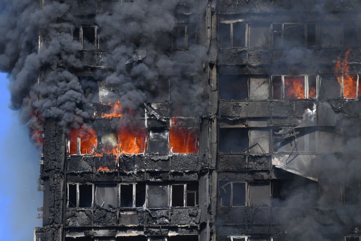 Smoke billows from the Grenfell Tower where at least 12 people were killed in a fire and 74 were injured