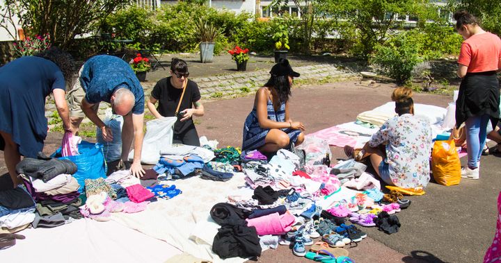 Volunteers categorise clothing donations by kind and size