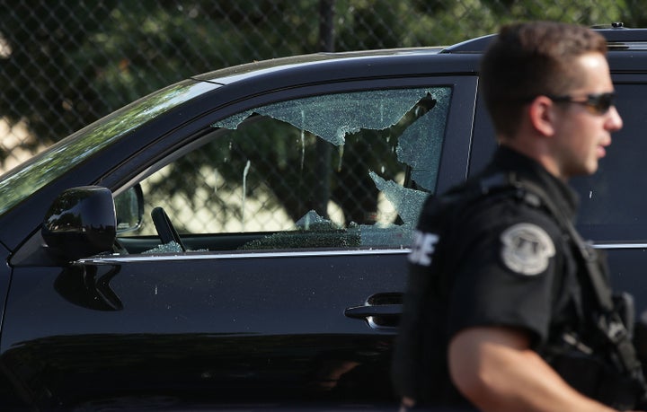 A broken window on a vehicle is seen outside Eugene Simpson Stadium Park, where the shooting took place.