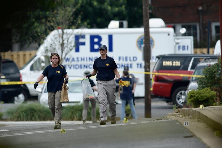 Member of the FBI inspect the crime scene after a shooting during a practice of the Republican congressional baseball at Eugene Simpson Stadium Park.