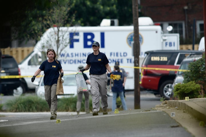 Member of the FBI inspect the crime scene after a shooting during a practice of the Republican congressional baseball at Eugene Simpson Stadium Park. 