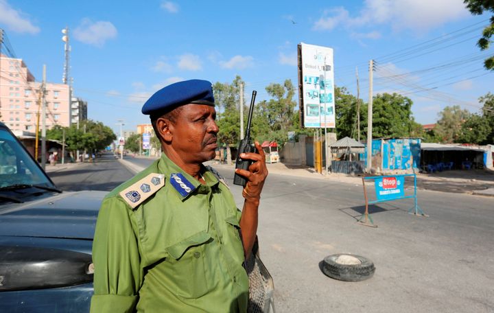 A Somali policeman stands guard along a road which was blocked to control motor vehicle traffic in Mogadishu on February 7.