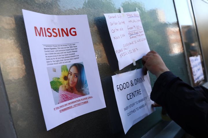 Messages about missing residents and free services are displayed near the London tower block which was destroyed in a fire disaster on Wednesday.