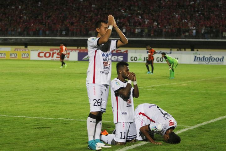 Bali United soccer players Ngurah Nanak, Yabes Roni and Miftahul Hamdi pray regarding their religion as they celebrate goals during their match against Perseru Serui FC, in Gianyar, Indonesia June 4, 2017.