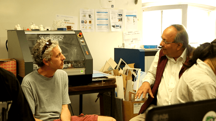  Samir Brahmachari (right) speaks with Ariel Lindner, cofounder of the Centre for Research and Interdisciplinarity and its director of research. 