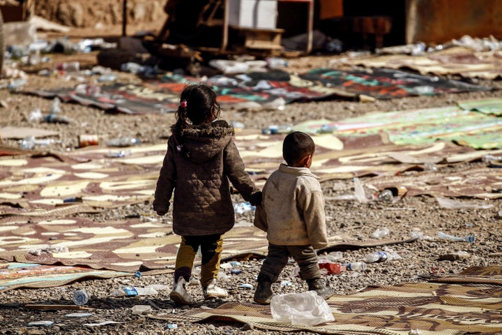 Two Iraqi children who just fled their homes wait to be transported to a nearby refugee camp in western Mosul, Iraq February 28, 2017.