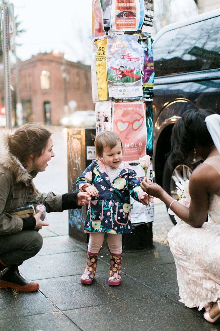 The toddler received a special princess flower from the bride.