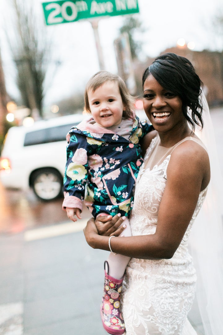 The beaming bride and her adorable fan.