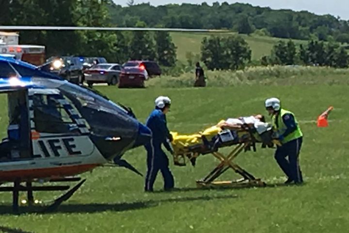 Medical personnel transport the injured pilot.