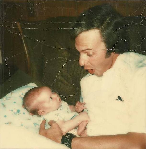 Dad, trying to elicit a smile from me as a newborn, July 1974