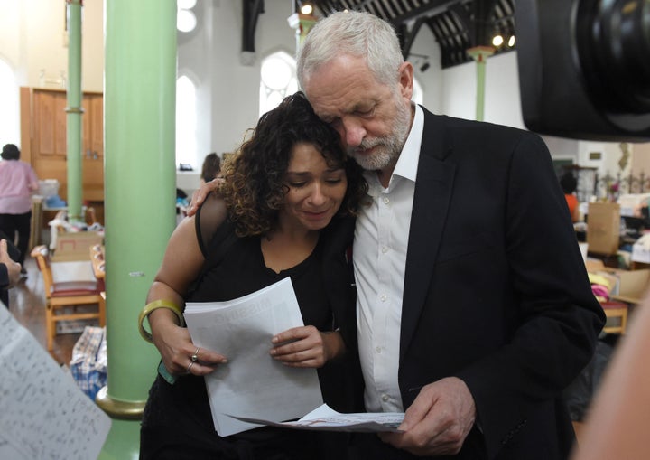 Britain's oppositon Labour Party leader Jeremy Corbyn meets a local resident following a fatal fire in a tower block in west