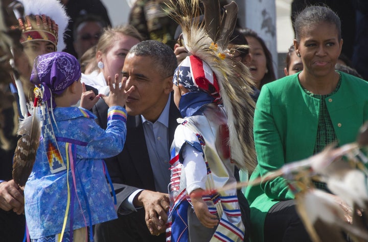 President Barack Obama talks with Native American performers during the Cannon Ball Flag Day Celebration in Cannon Ball, Nort