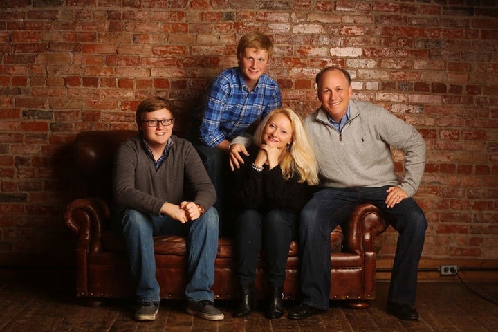 Nancy Holland with her husband Jim and their sons Dane (seated) and Chance.