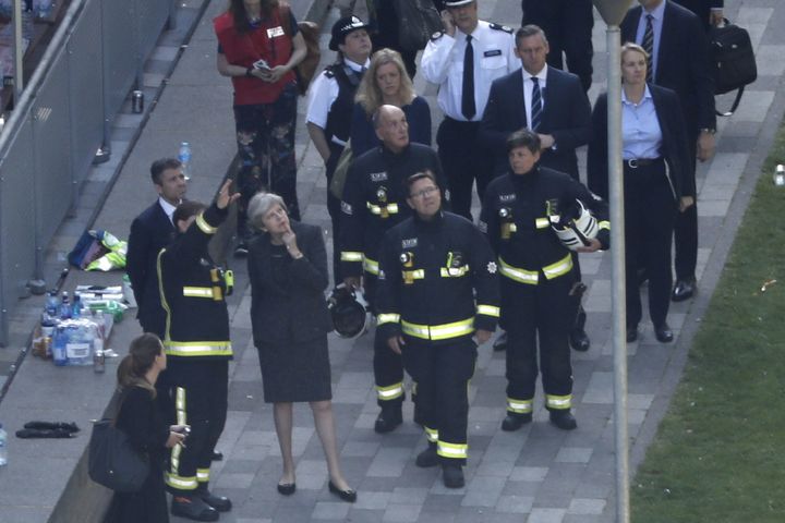 Prime Minister Theresa May speaks to fire chief Dany Cotton during a visit to Grenfell Tower