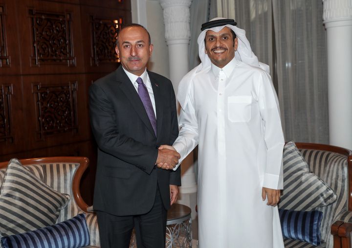 Turkish Foreign Minister Mevlut Cavusoglu (L) and Qatari Foreign Minister Sheik Mohammed bin Abdulrahman Al Sani (R) shake hands as they pose for a photo during their meeting in Doha, Qatar on June 14, 2017.