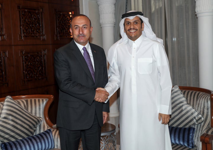 Turkish Foreign Minister Mevlut Cavusoglu (L) and Qatari Foreign Minister Sheik Mohammed bin Abdulrahman Al Sani (R) shake hands as they pose for a photo during their meeting in Doha, Qatar on June 14, 2017.