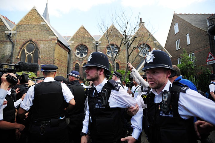 Police try to deal with crowds outside the church