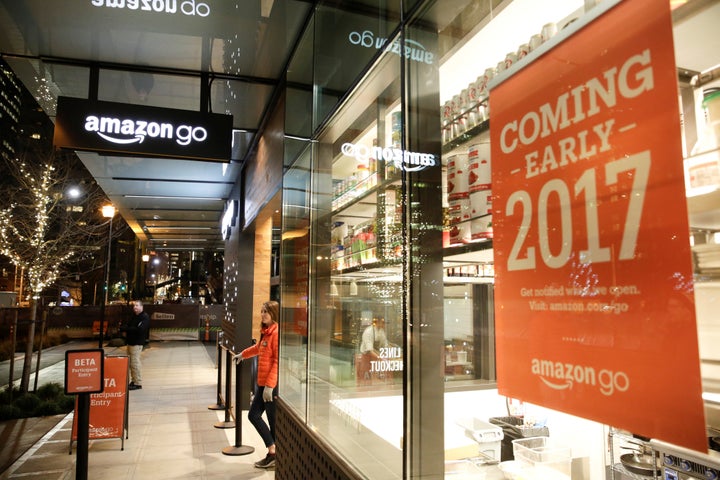 An employee outside an Amazon Go, a brick-and-mortar grocery store without lines or checkout counters, in Seattle on Dec. 5, 2016.