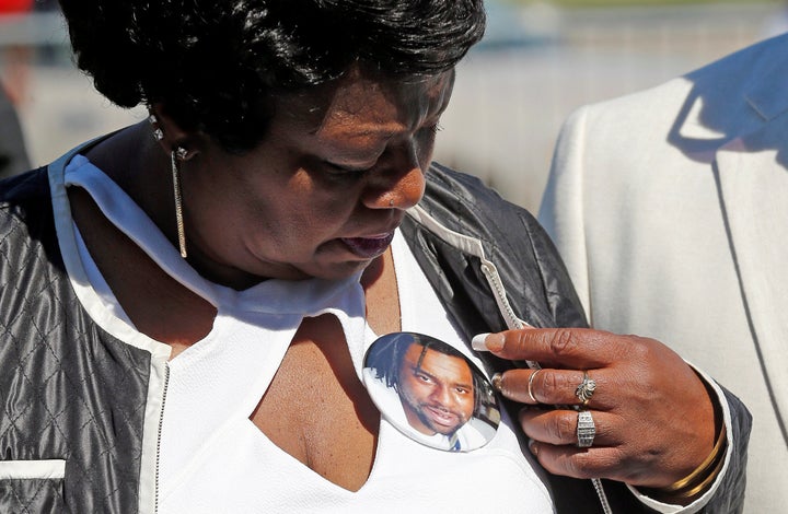 Valerie Castile looks at a photo button of her son Philando during a press conference on the state Capitol grounds in Saint Paul, Minnesota, July 12, 2016.