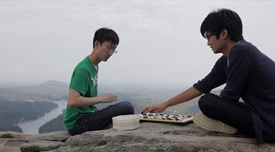 To escape the intensity of the American Professional Certification Tournament, Andy Liu and Evan Cho play a game of Go atop Chimney Rock in North Carolina 