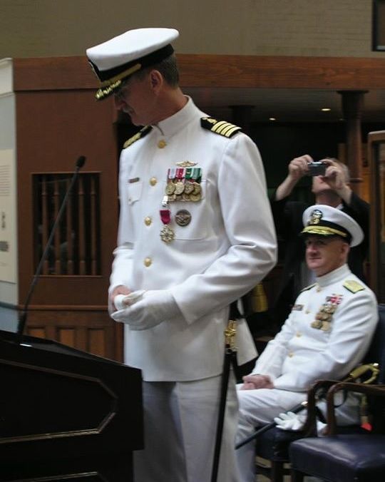 My father (standing, with saber) at his retirement ceremony.