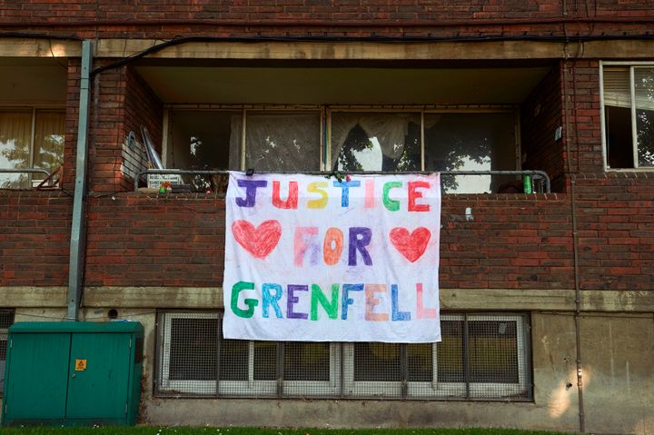 A banner reading ' justice for Grenfell' is pictured hanging from the balcony of a property near the Grenfell Tower block in Kensington on Saturday