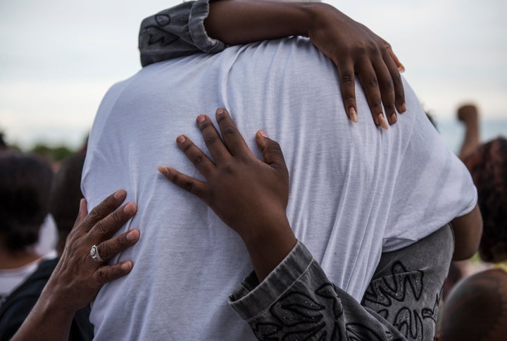 John Thompson, a friend and former colleague of Philando Castile, is embraced after speaking on the steps of the Minnesota State Capitol building on June 16, 2017