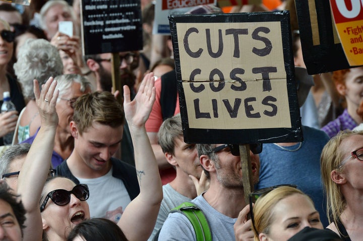 Demonstrators hold placards and chant during an anti-Conservative Party Leader and Britain's Prime Minister Theresa May, and Democratic Unionist Party (DUP) protest on Saturday