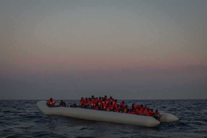 Refugees and migrants wait in a small rubber boat to be rescued by the crew of the Migrant Offshore Aid Station Phoenix vessel off Lampedusa, Italy, on June 10.