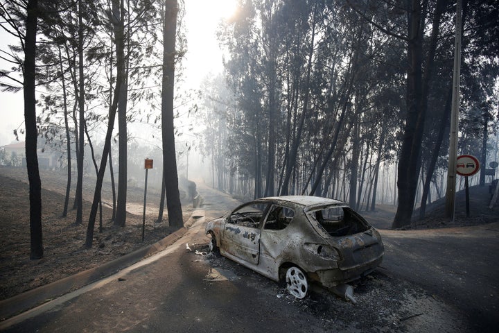 A burned car is seen in the aftermath of a forest fire near Pedrogao Grande, in central Portugal, June 18, 2017. (REUTERS/Raf
