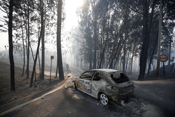 A burned car is seen in the aftermath of a forest fire near Pedrogao Grande, in central Portugal, June 18, 2017. (REUTERS/Rafael Marchante)