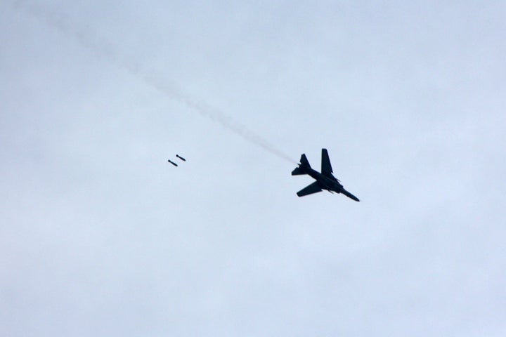 A warplane loyal to Syria's President Bashar al-Assad fires rockets during an air strike in eastern Al-Ghouta.