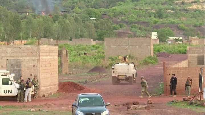 An armoured vehicle drives towards Le Campement Kangaba resort following an attack where gunmen stormed the resort in Dougourakoro.