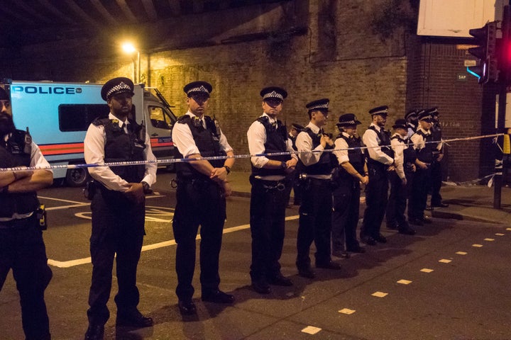 Police officers stand guard near Finsbury Park Mosque. 