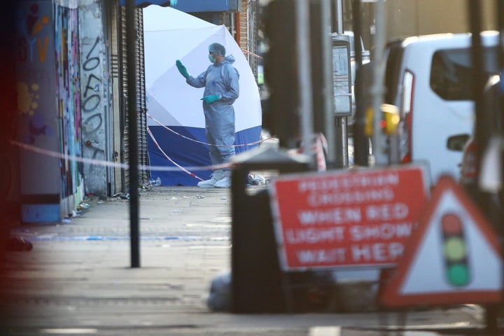 Forensic officers attend to the scene after a vehicle collided with pedestrians in the Finsbury Park neighborhood of North Lo