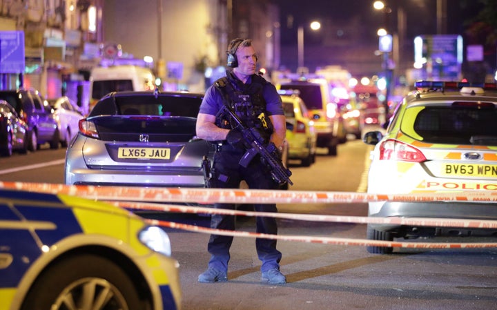 An armed police officer mans a cordon on the Seven Sisters Road at Finsbury Park in north London.