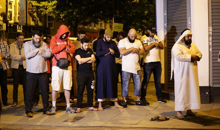 Local people observe prayers at Finsbury Park in north London, where one person has been arrested after a vehicle struck pedestrians, leaving 'a number of casualties'.