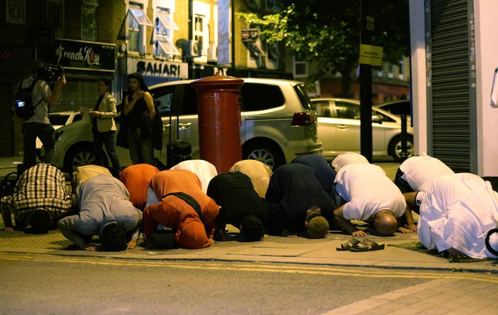 Muslim men pray after the terror attack in Finsbury Park.