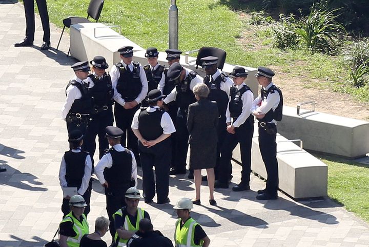 Theresa May meets police near Grenfell Tower last week.