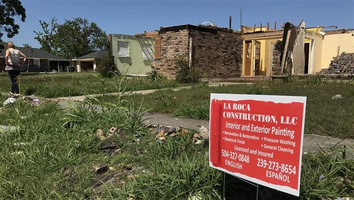 Contractor signs litter the front yards of houses damaged by a February tornado in east New Orleans.