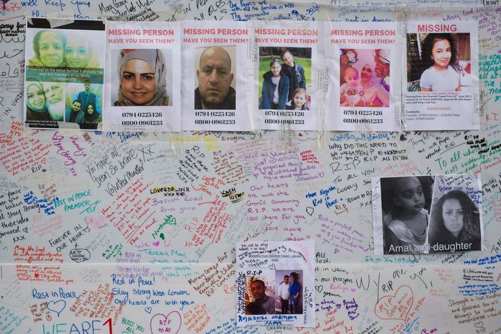 Tributes and missing posters are left on a wall near Latimer Road, close to Grenfell Tower.