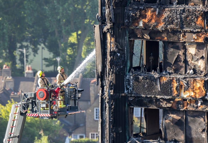 Water is sprayed on Grenfell Tower in west London after a fire engulfed the 24-storey building.