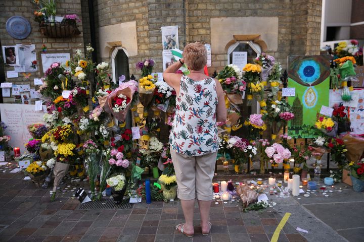 People look at tributes at Notting Hill Methodist Church near Grenfell Tower in west London.