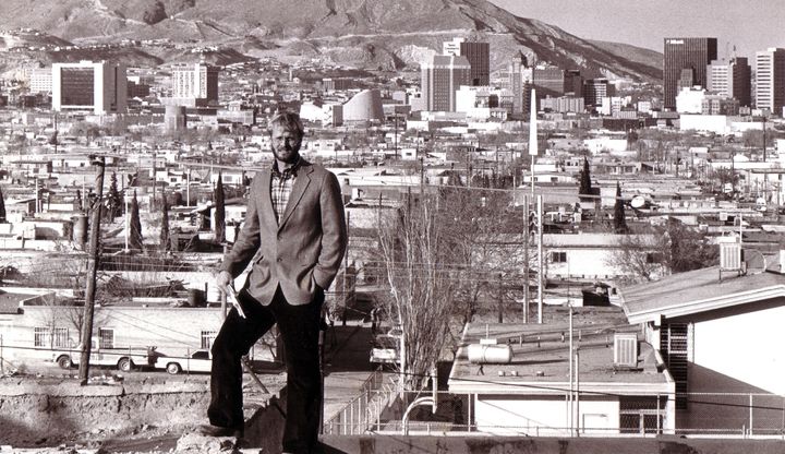 Journalist David M. Hancock seen here in 1986-87, standing on a hill in Ciudad Juarez with downtown El Paso, Texas, in the background 