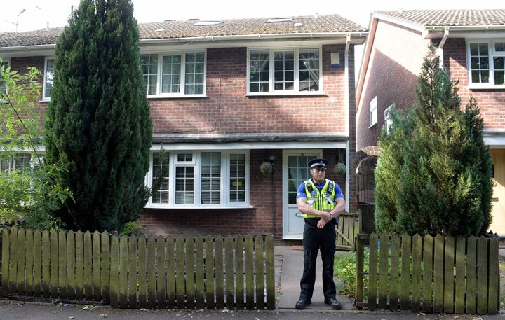 A police community support officer stands at the front of a residence in Cardiff, as searches are being carried out in connection with the attack near to a Finsbury Park Mosque in north London