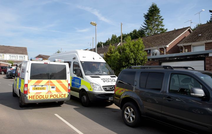 Police vehicles at the rear of a residence in Cardiff, as searches are being carried out in connection with the attack near to a Finsbury Park Mosque in north London